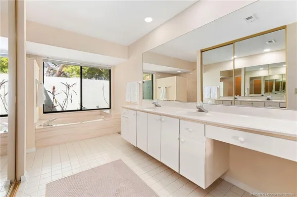 a large bathroom with a large tub and sink