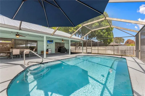a view of a backyard with swimming pool