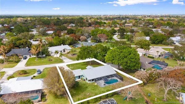 an aerial view of residential houses with outdoor space