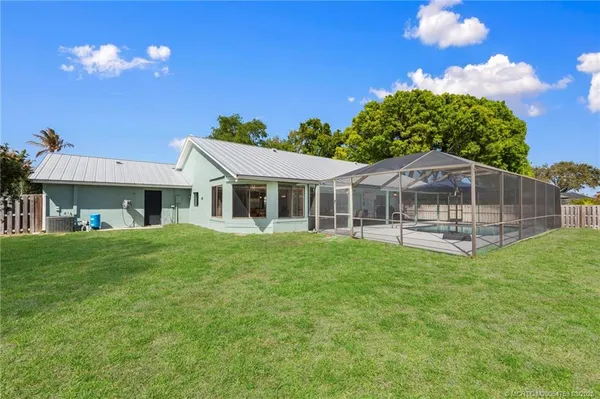 a front view of house with yard and outdoor seating