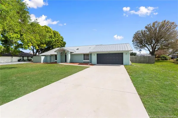 a front view of house with a garden
