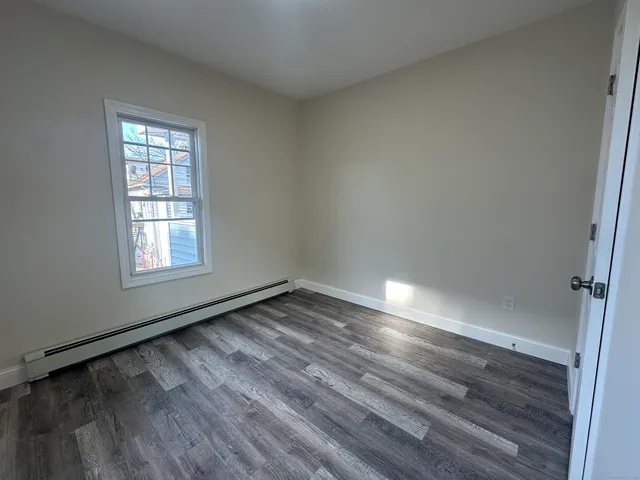 a view of an empty room and wooden floor