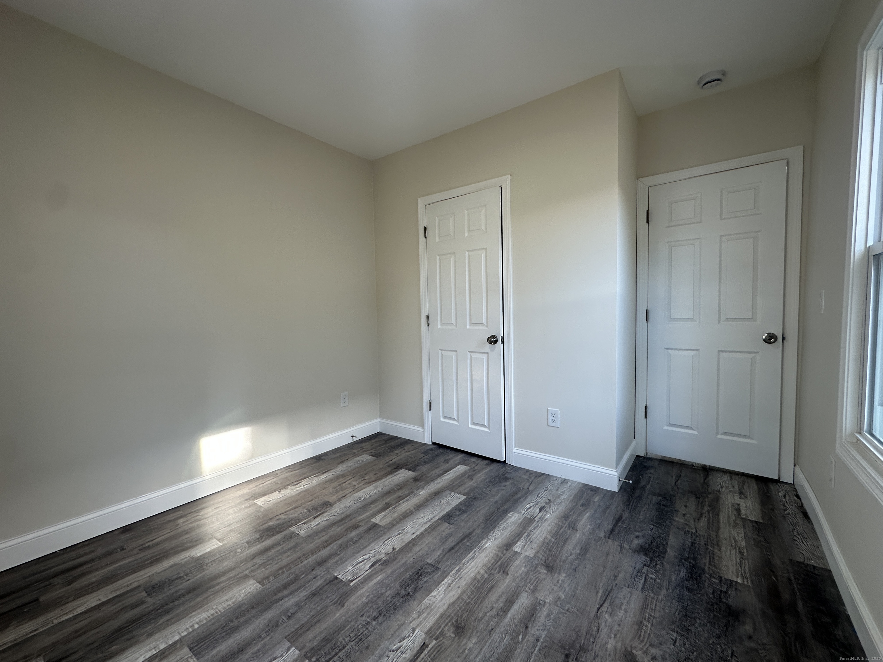 85 Twiss Street Meriden, CT 06450 - Photo 18 of 23 a view of an empty room and wooden floor