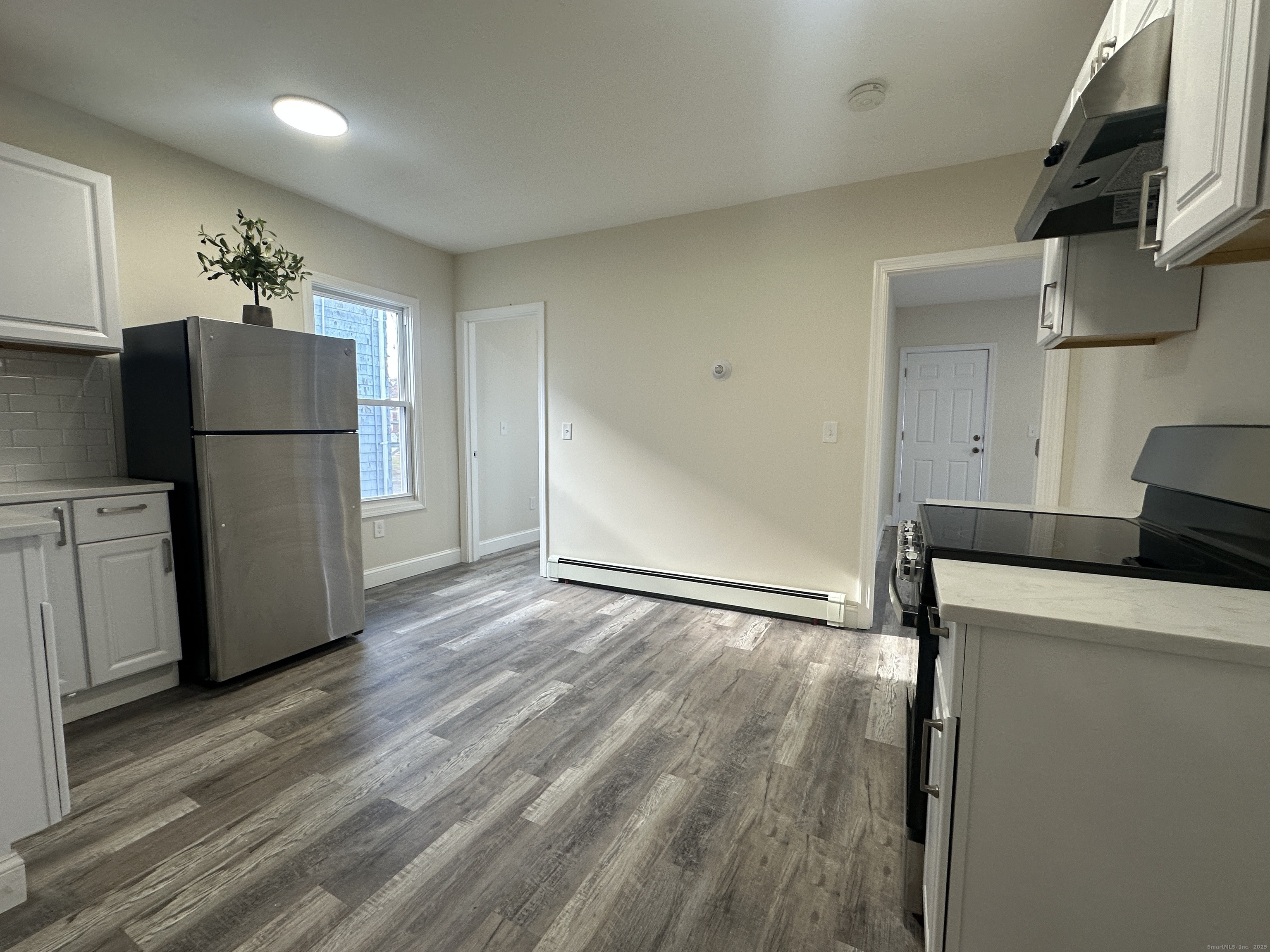 85 Twiss Street Meriden, CT 06450 - Photo 5 of 23 a kitchen with a refrigerator and a stove top oven