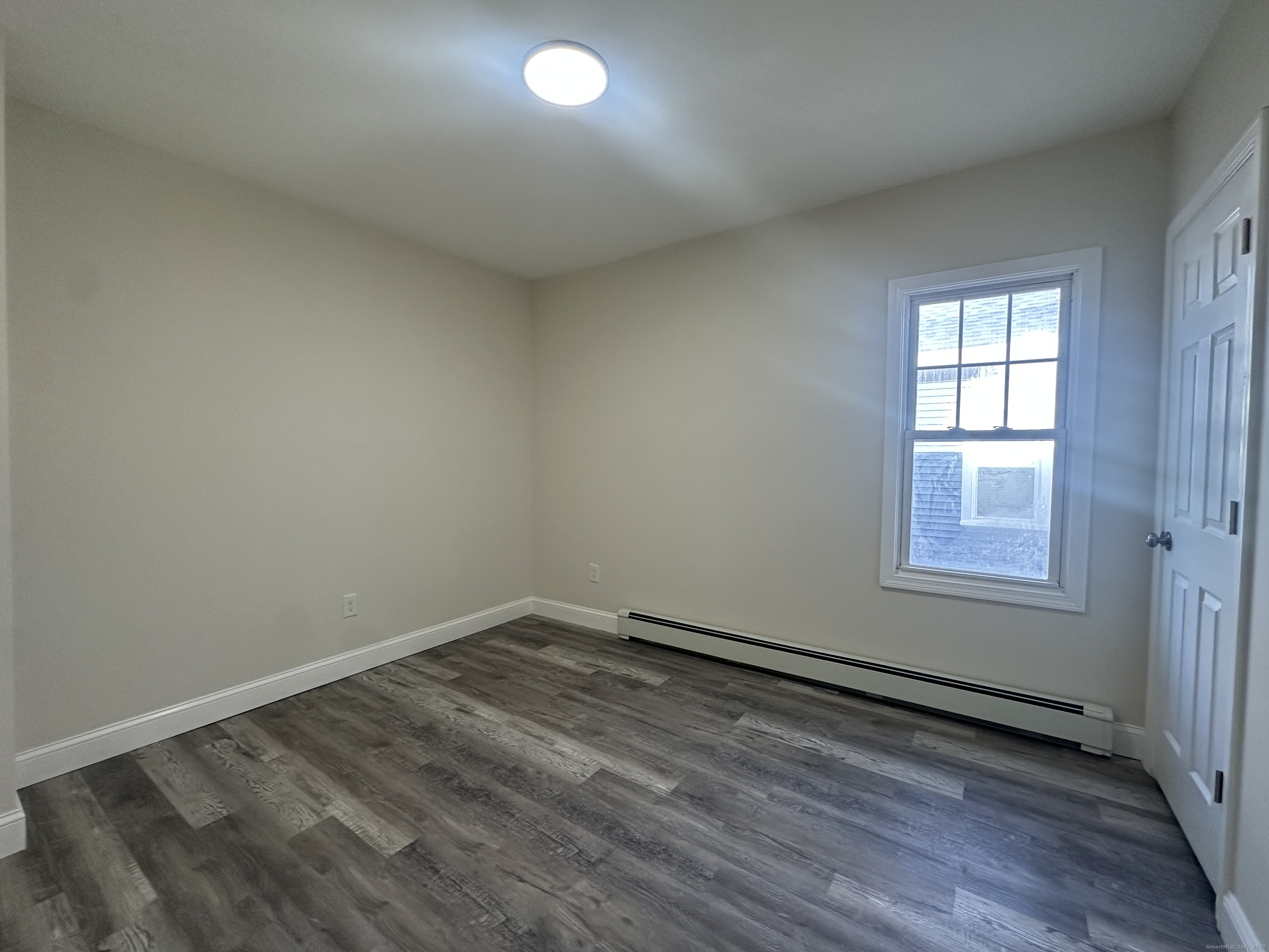 85 Twiss Street Meriden, CT 06450 - Photo 6 of 23 an empty room with wooden floor and windows