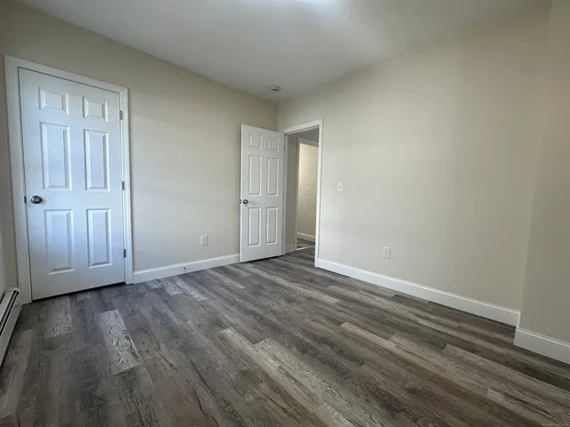 a view of an empty room and wooden floor