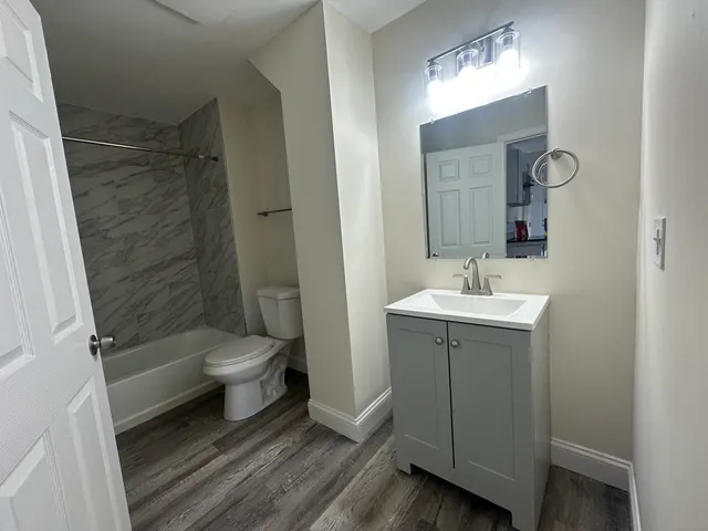 a bathroom with a sink toilet and shower