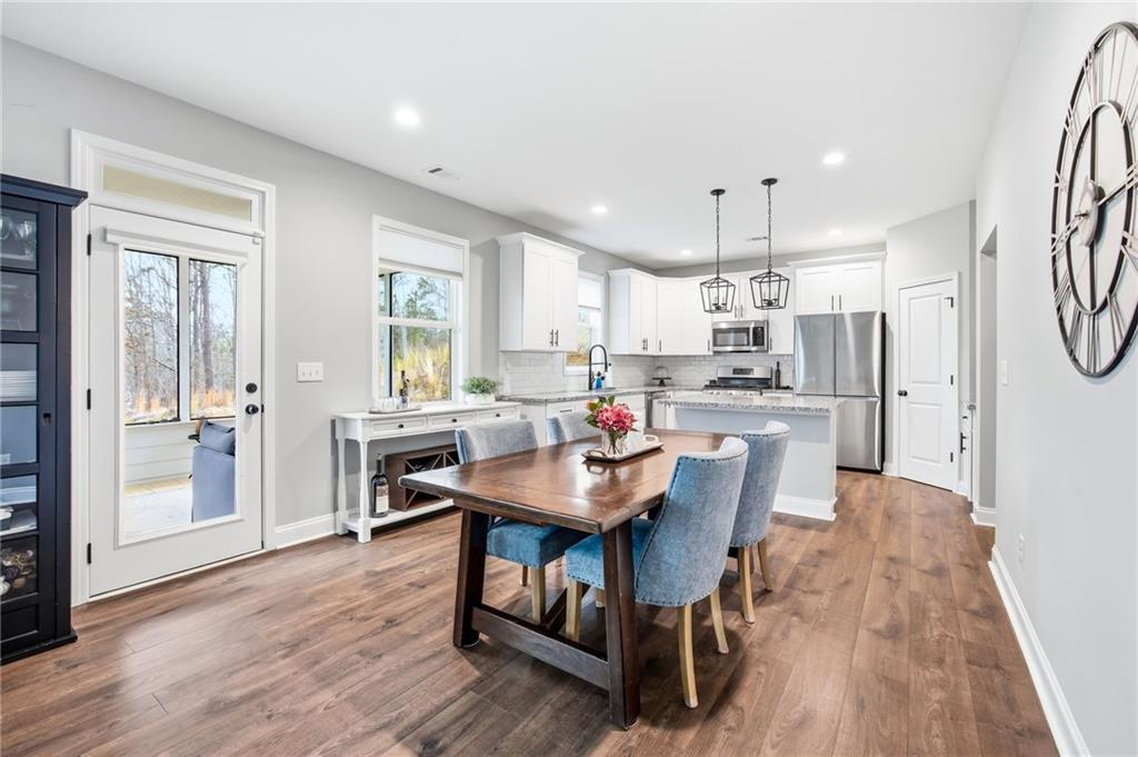 238 Observation Pointe Dallas, GA 30132 - Photo 12 of 41 a kitchen with kitchen island a wooden floor and a refrigerator