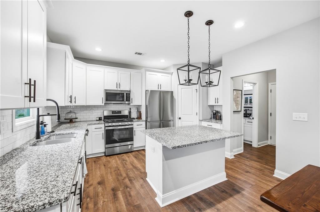 238 Observation Pointe Dallas, GA 30132 - Photo 15 of 41 a kitchen with kitchen island granite countertop a stove oven and refrigerator