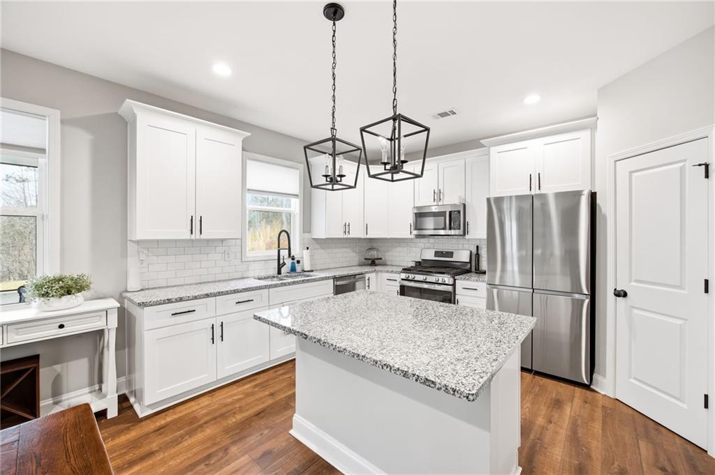 238 Observation Pointe Dallas, GA 30132 - Photo 2 of 41 a kitchen with a refrigerator a sink and wooden floor