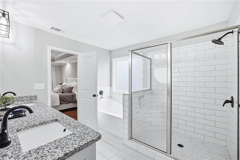 238 Observation Pointe Dallas, GA 30132 - Photo 23 of 41 a bathroom with a granite countertop sink a mirror and shower