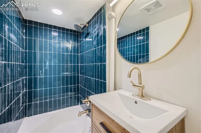 a bathroom with a sink a shower a mirror and shower