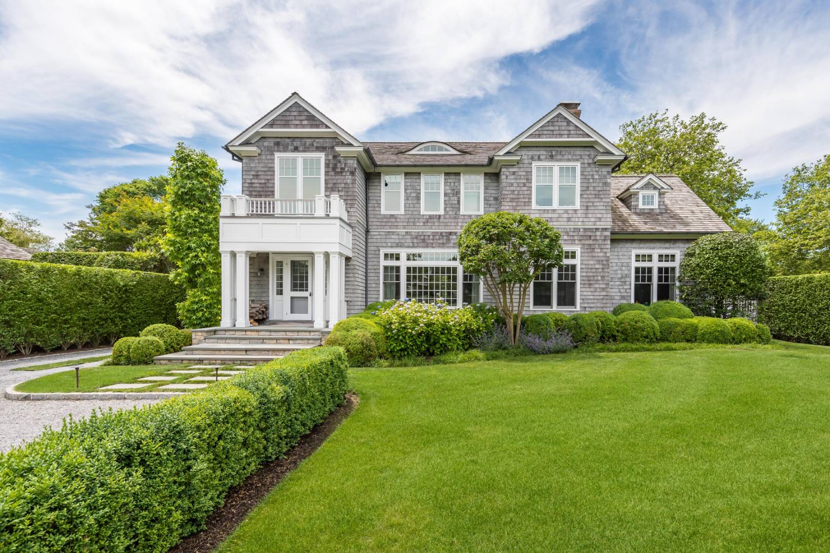 95 Egypt Lane East Hampton, NY 11937 - Photo 1 of 37 a front view of a house with a yard