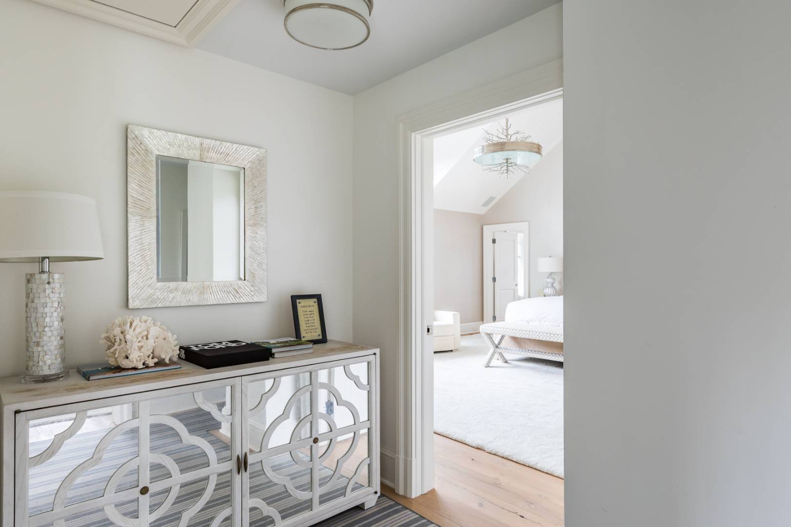 95 Egypt Lane East Hampton, NY 11937 - Photo 12 of 37 a bedroom with a bed and a mirror