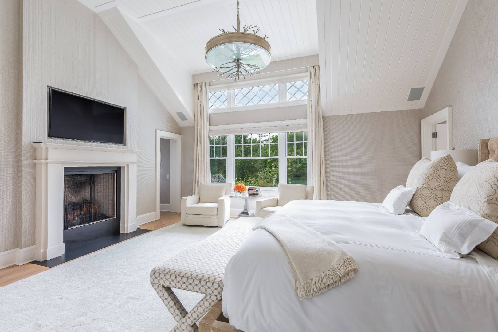 95 Egypt Lane East Hampton, NY 11937 - Photo 13 of 37 a bedroom with a bed and a fireplace