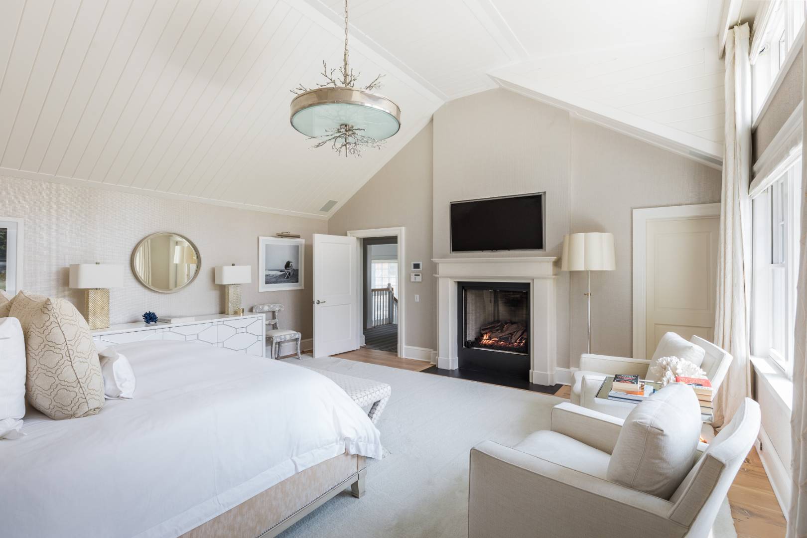 95 Egypt Lane East Hampton, NY 11937 - Photo 14 of 37 a bedroom with a bed and a fireplace