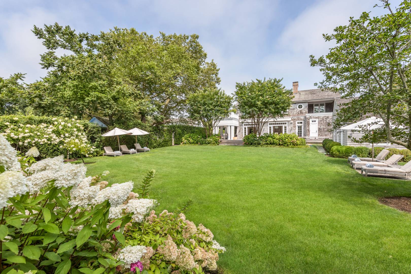 95 Egypt Lane East Hampton, NY 11937 - Photo 35 of 37 a view of a house with a yard