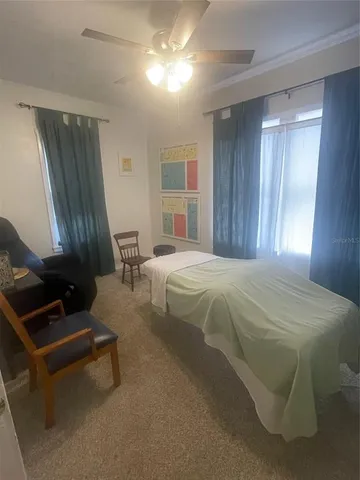 a spacious bedroom with a bed and window