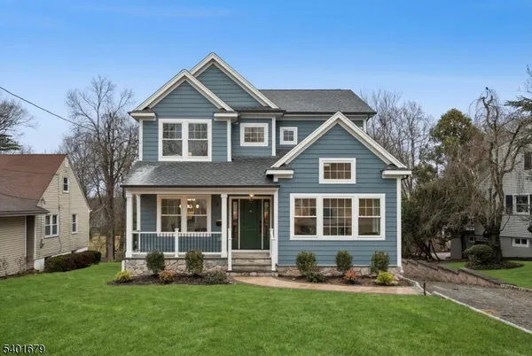 a living room with furniture and floor to ceiling windows
