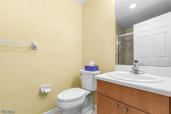 a bathroom with a sink mirror vanity and toilet