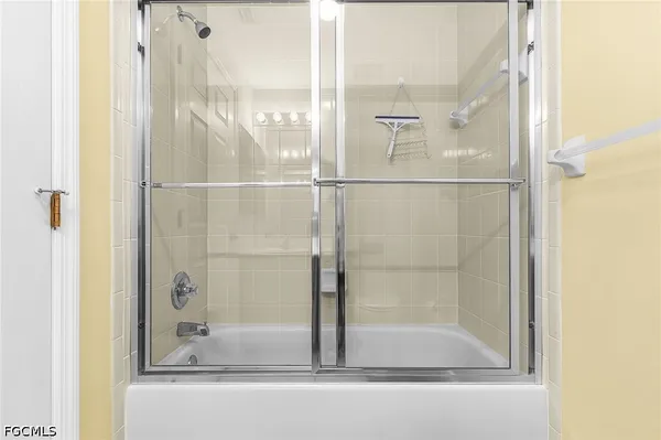 a bathroom with a glass shower door