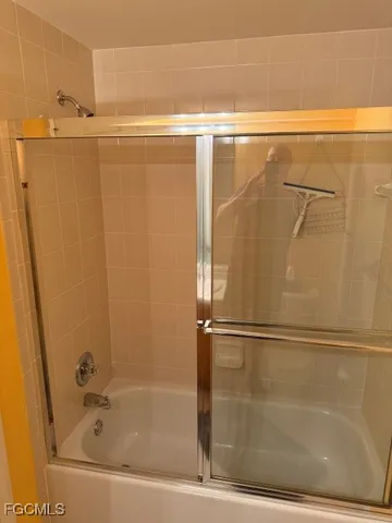a bathroom with a shower and a bath tub