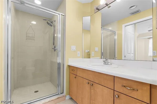 a bathroom with a shower sink and mirror