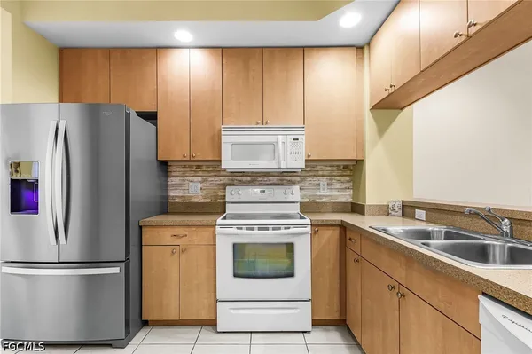 a kitchen with a stove refrigerator and microwave