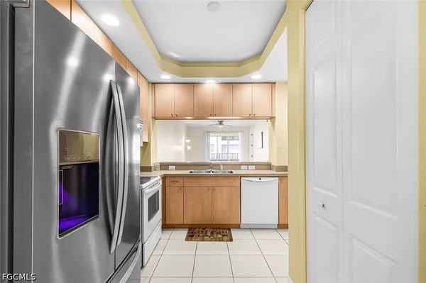 a kitchen with stainless steel appliances granite countertop a refrigerator and a stove