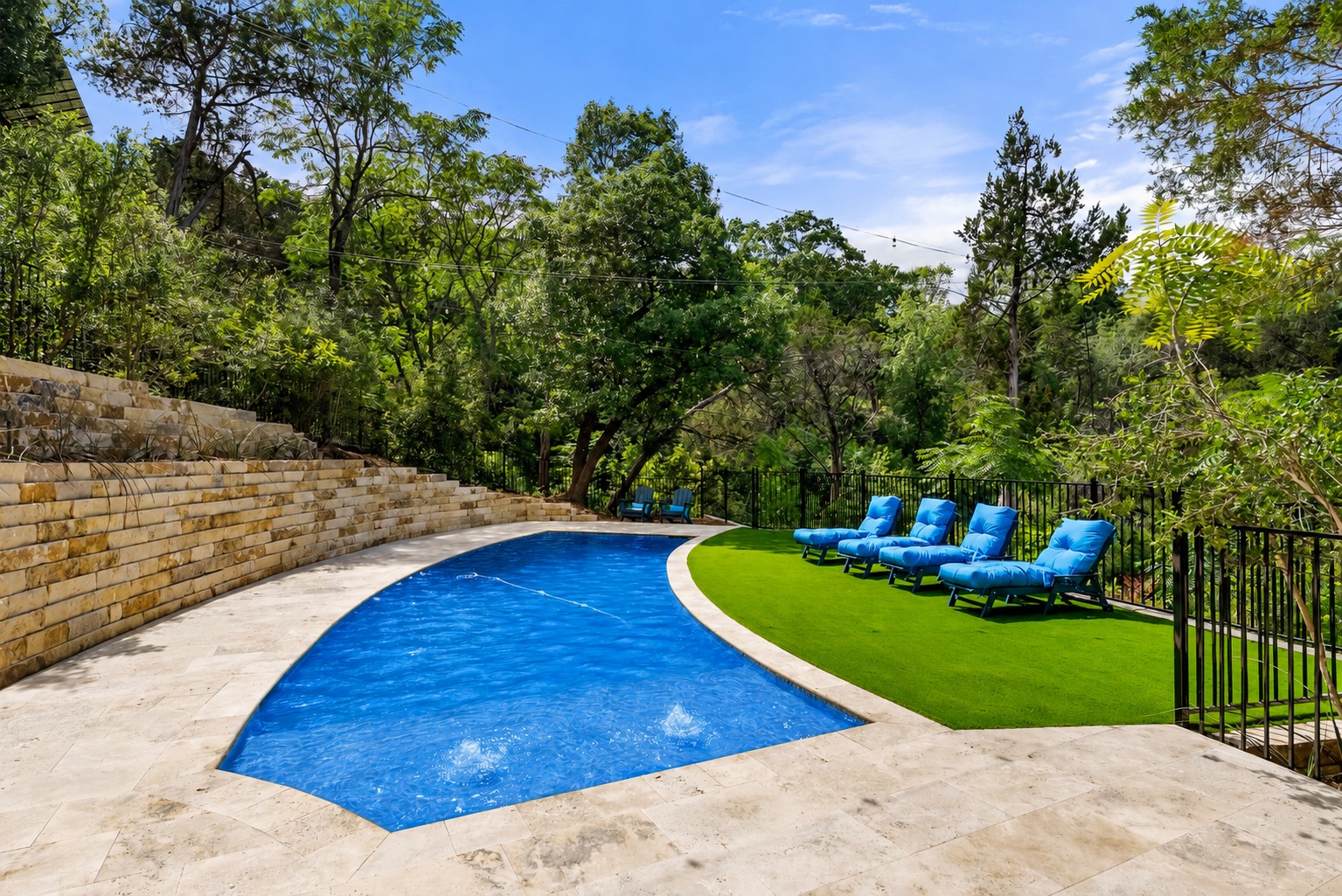 1354 The High Road Austin, TX 78746 - Photo 21 of 40 An inviting in-ground pool with surrounding patio offers a tranquil retreat amidst lush landscaping.
