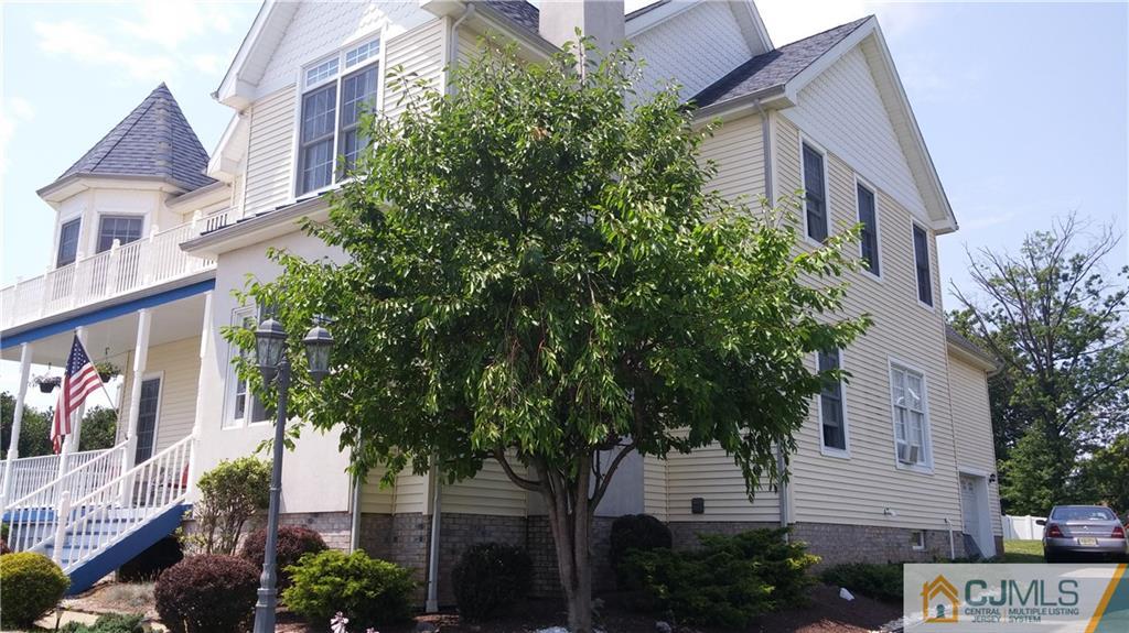 410 Cliff Road Sewaren, NJ 07077 - Photo 2 of 4 a front view of a multi story building with a yard