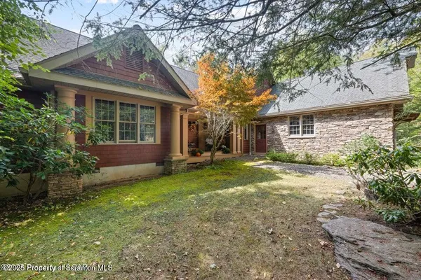 a view of a house with yard and tree s
