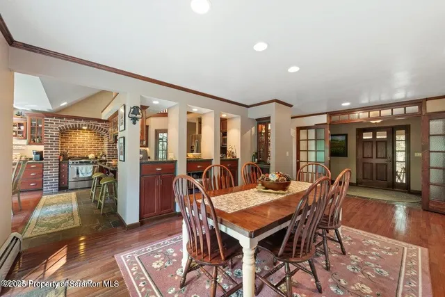 a dining room with furniture and wooden floor