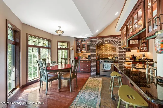 a dining room with furniture and wooden floor