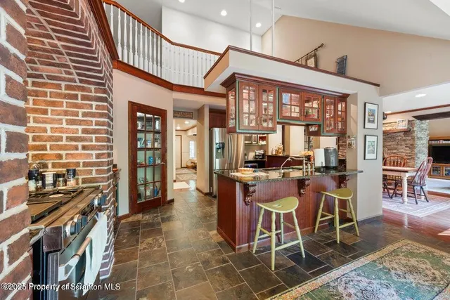 a view of a dining room with furniture a chandelier and wooden floor