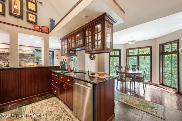 a kitchen with stainless steel appliances granite countertop a stove and cabinets