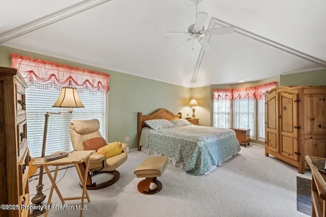 a bed sitting in a spacious bedroom next to a window