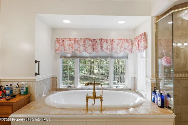 a spacious bathroom with a granite countertop sink a toilet and shower