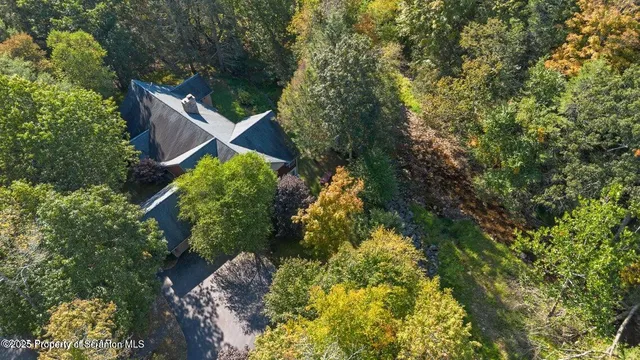 an aerial view of a house with garden space and deck