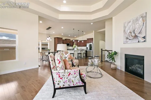 a kitchen with stainless steel appliances granite countertop a sink a stove and a wooden cabinets