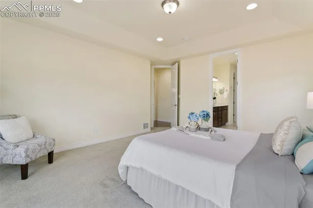 a bedroom with a bed and a lamp