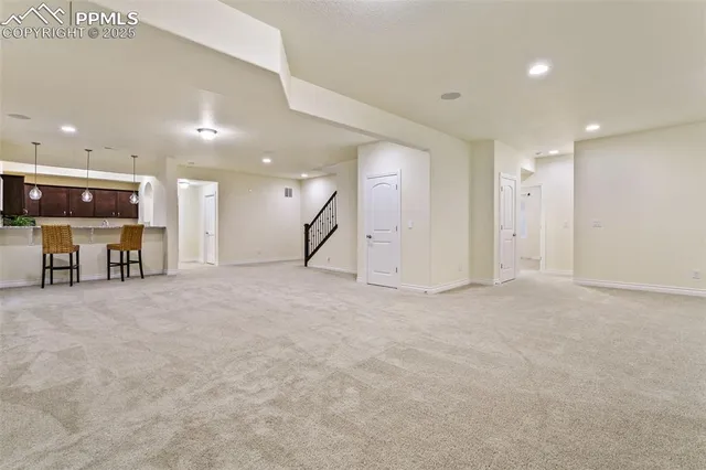 a bathroom with a granite countertop double vanity and a mirror