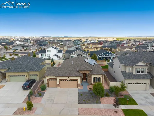 an aerial view of residential building with parking