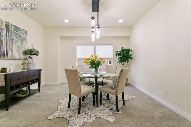 a view of a dining room with furniture and a chandelier
