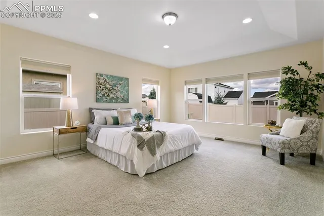 a spacious bedroom with a bed and a window