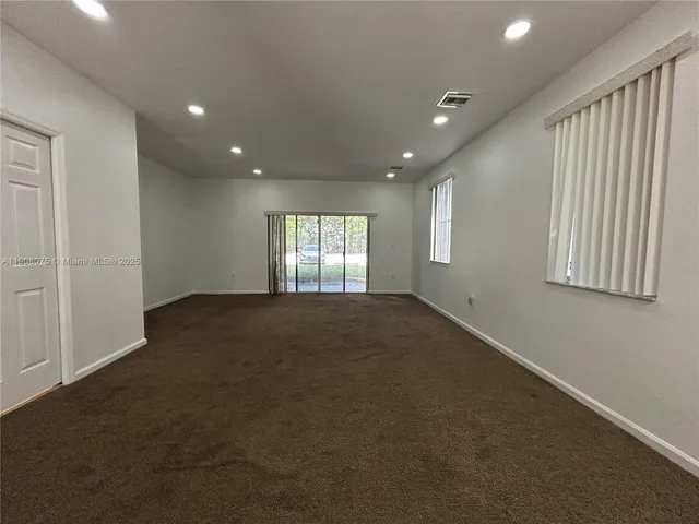 a view of empty room with windows