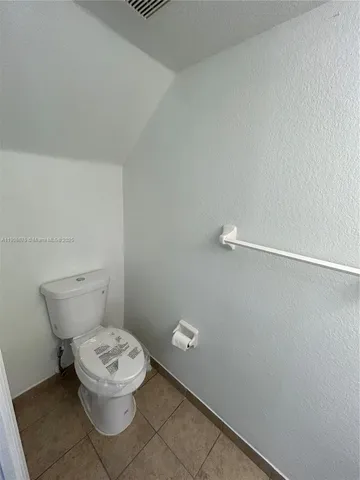 a white toilet sitting next to a white sink