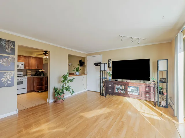 a bedroom with a bed and a flat tv screen on the dresser