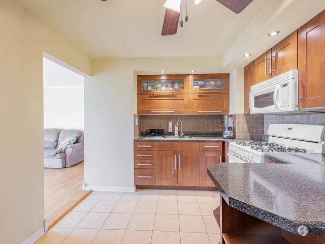 a kitchen with stainless steel appliances granite countertop a stove and a sink