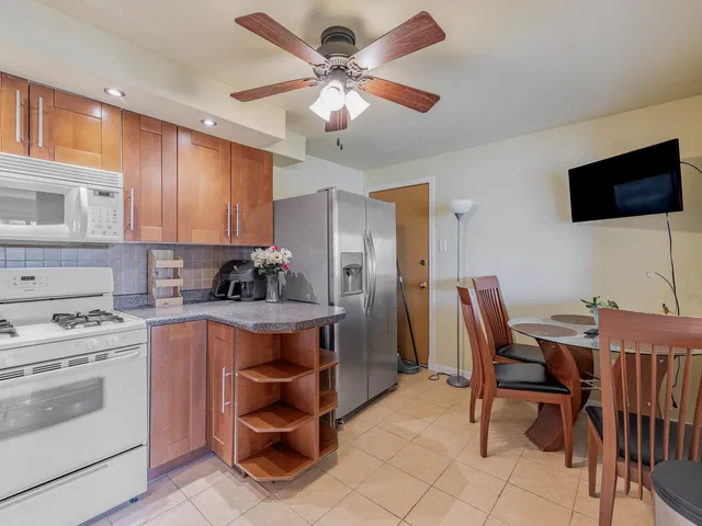 a kitchen with a stove a table and chairs